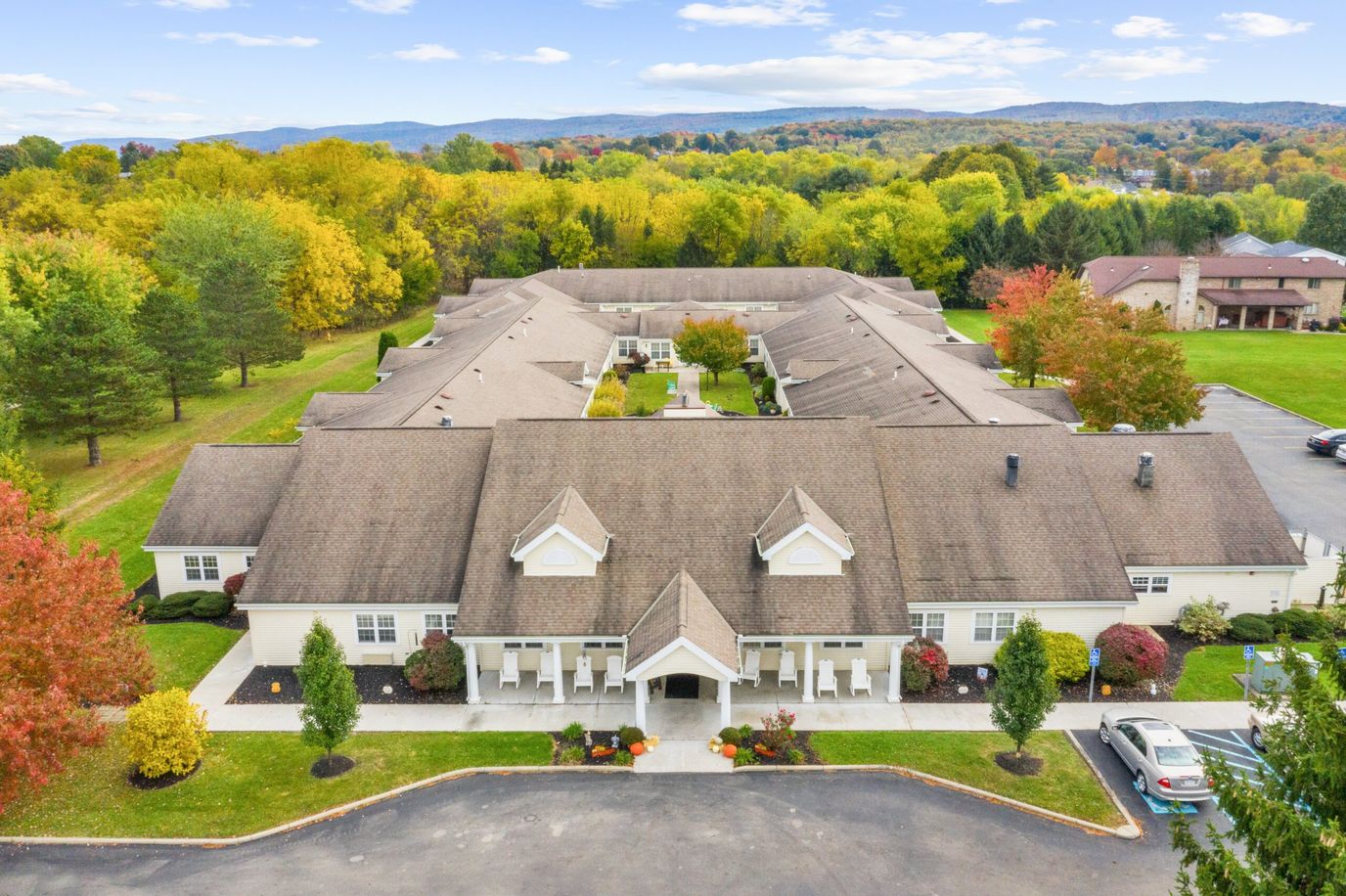 Aerial view of a senior living facility surrounded by trees