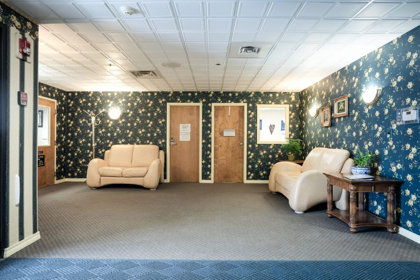 Interior of a common area with floral wallpaper and seating