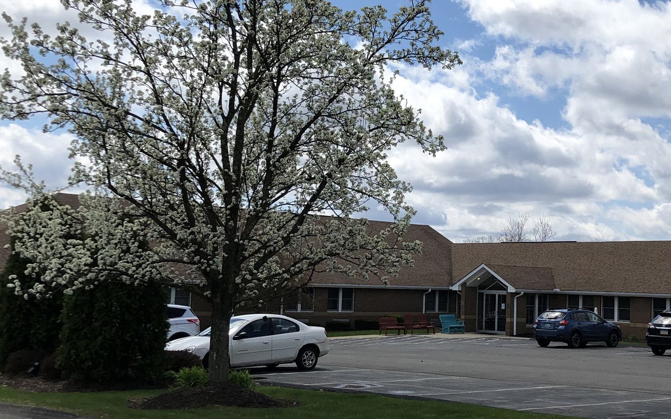 Exterior view of a nursing home with flowering tree