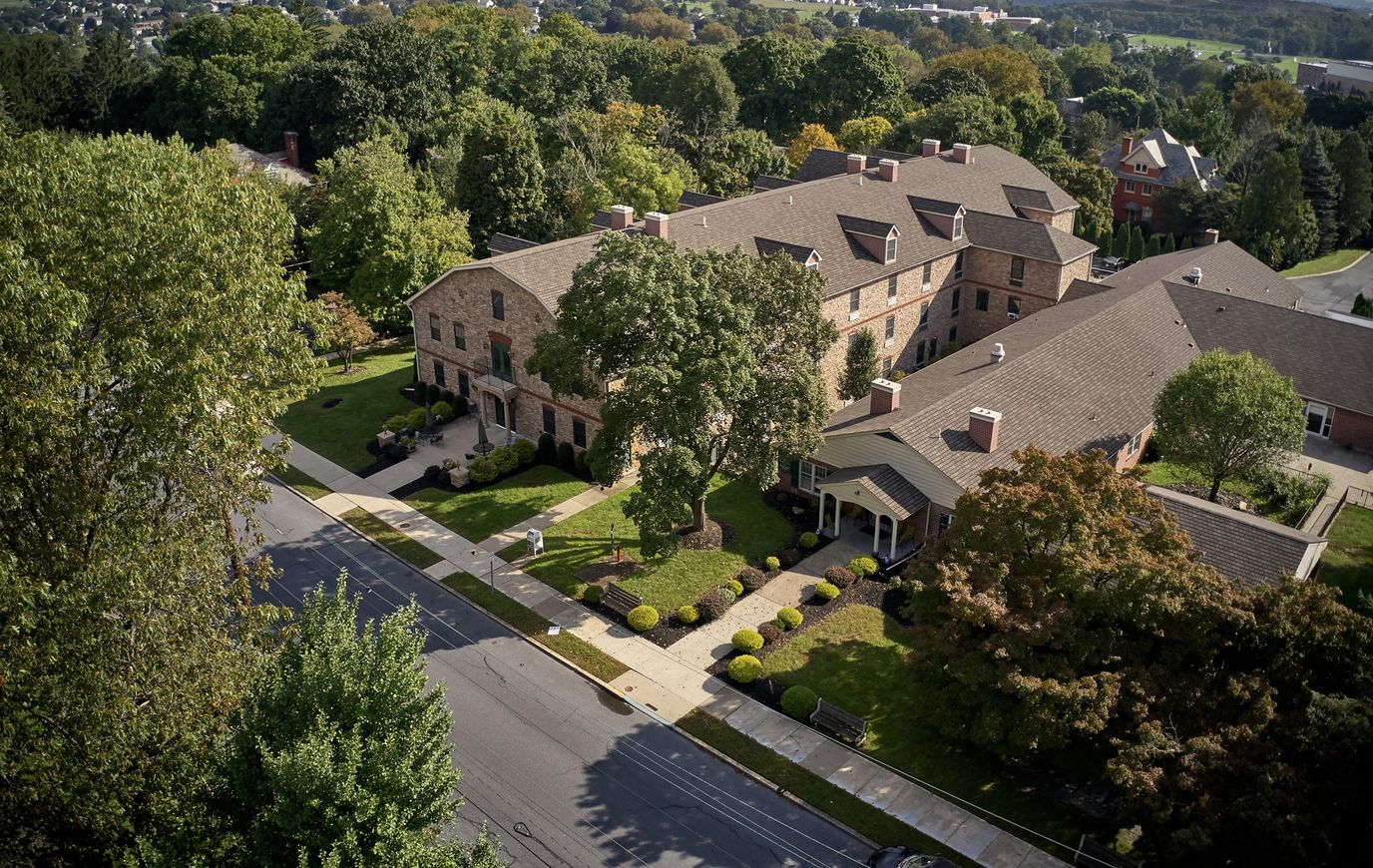 Aerial view of a senior living facility surrounded by greenery