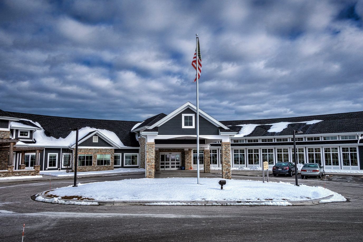 Front entrance of Sheboygan Senior Community with American flag