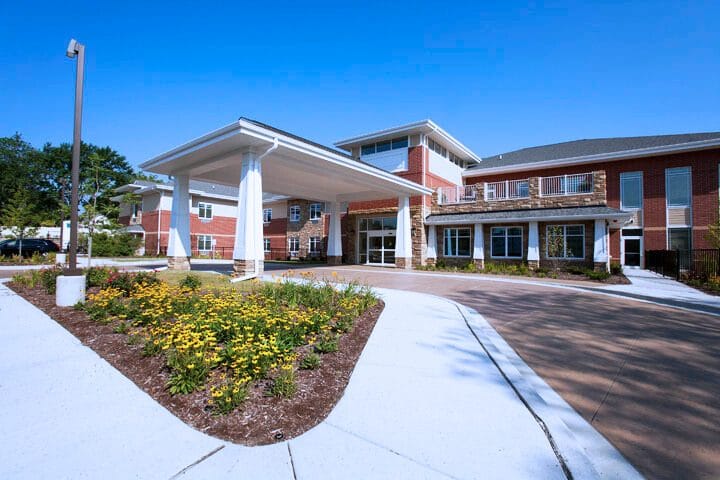 Front entrance of New Summit Rehabilitation and Healthcare facility with landscaping
