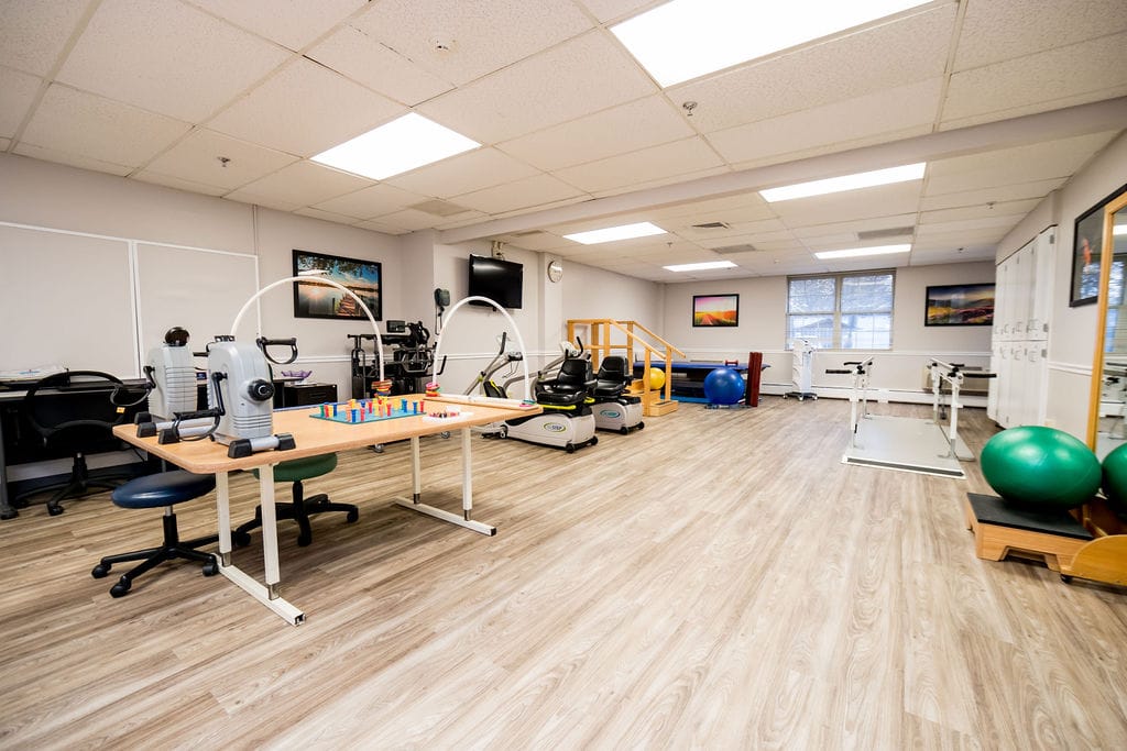 Bright and spacious physical therapy room with equipment
