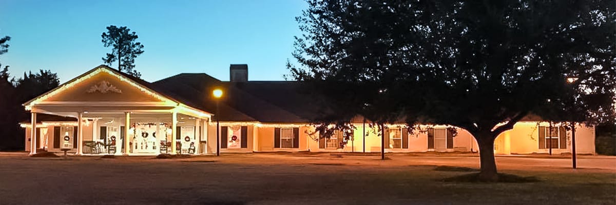 Exterior view of the facility at dusk with lights