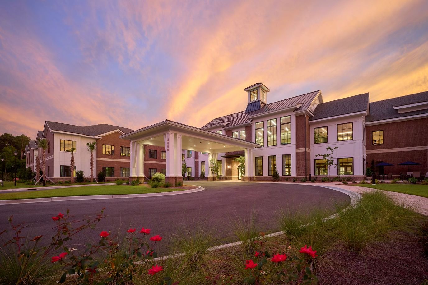 Exterior view of a senior living facility during sunset