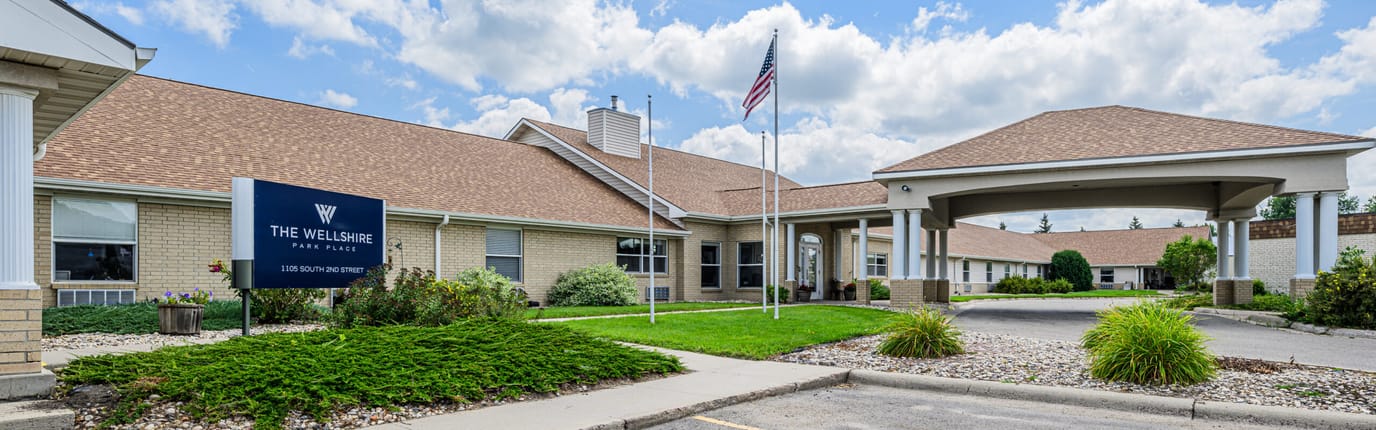 Exterior view of Wellshire Park Place with entrance and landscaping