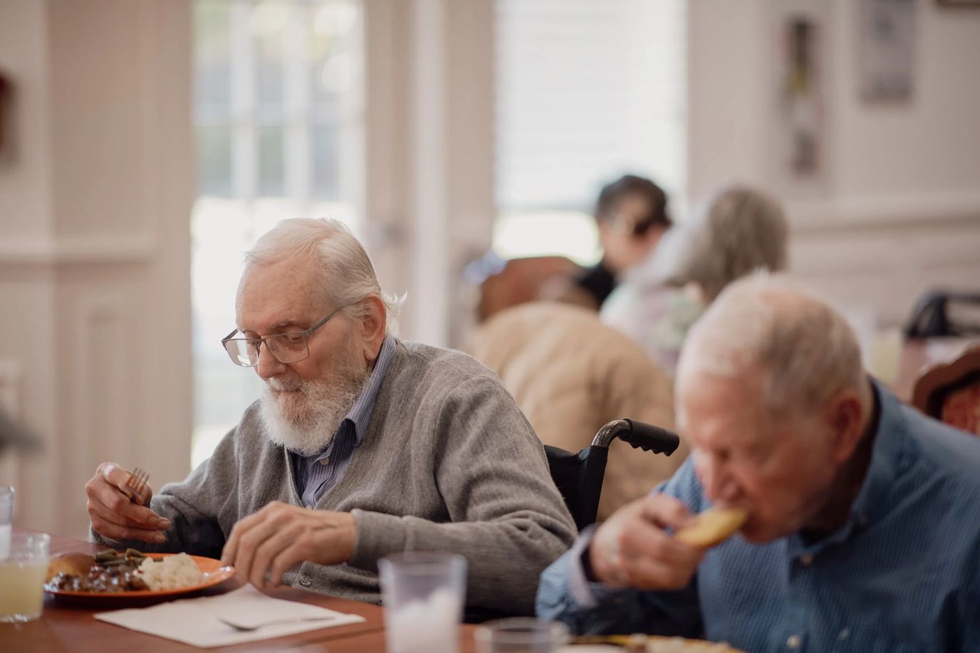 Residents enjoying meals in a dining area