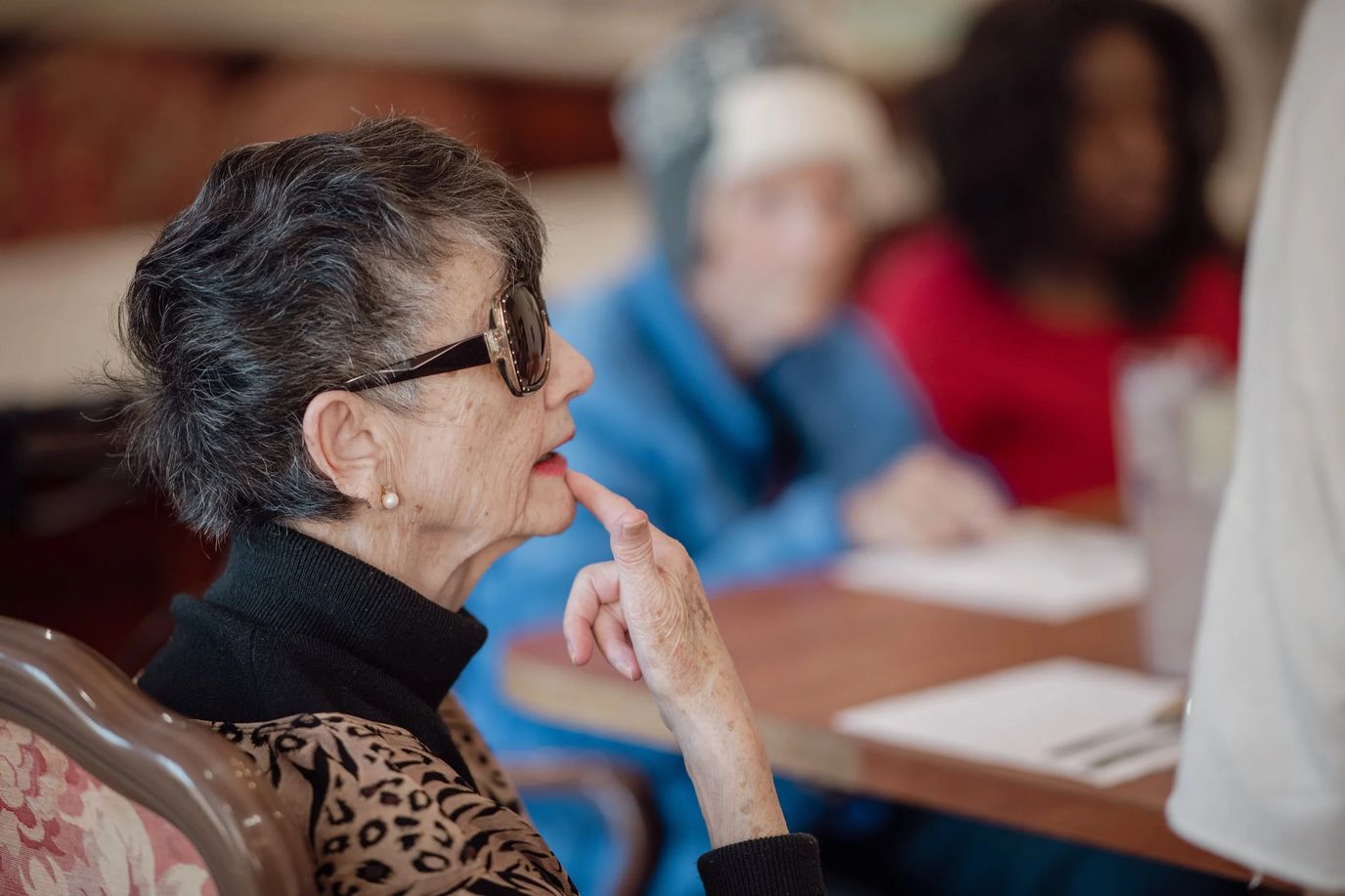 Residents engaged in a thoughtful discussion at a table