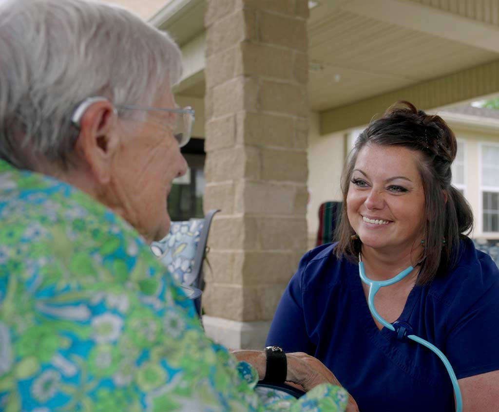 Staff member engaging with a resident outdoors