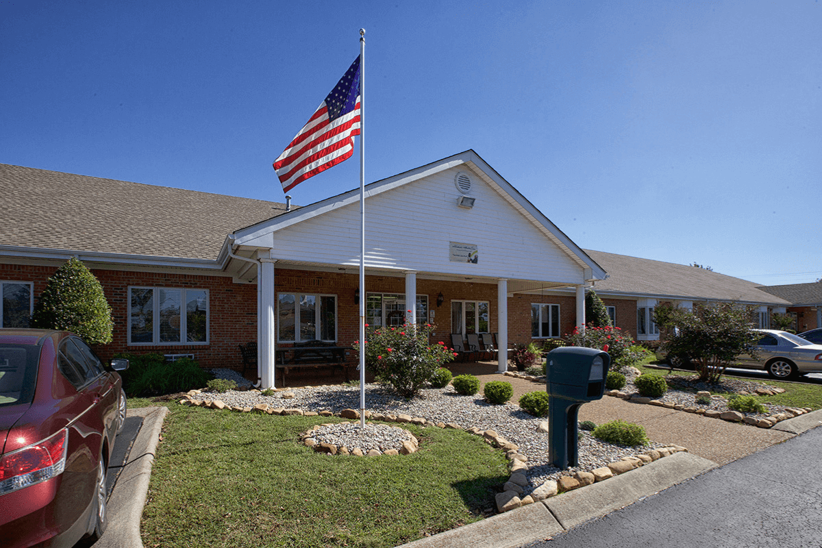 Exterior view of a nursing home with landscaped grounds