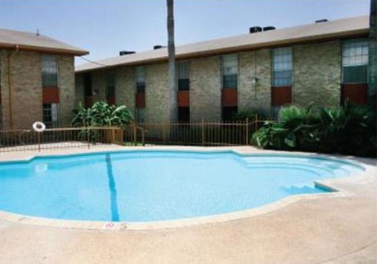 Outdoor pool area with surrounding building