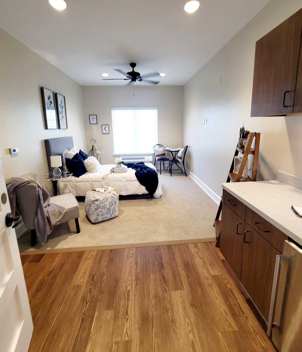 Cozy resident room with bed and kitchenette