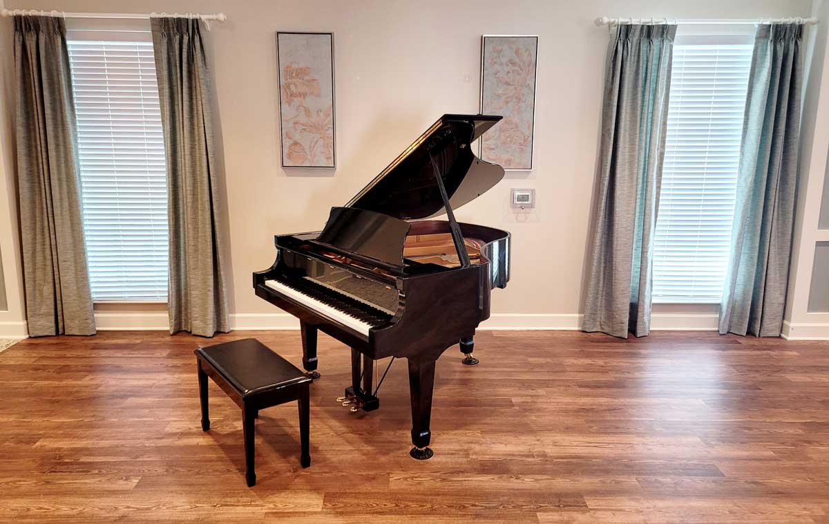 A grand piano in a bright common area