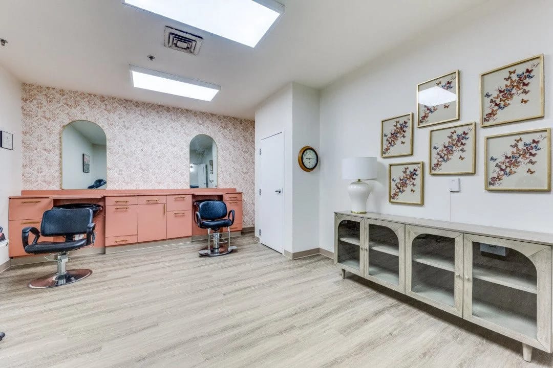 Brightly lit salon area with styling chairs and decor