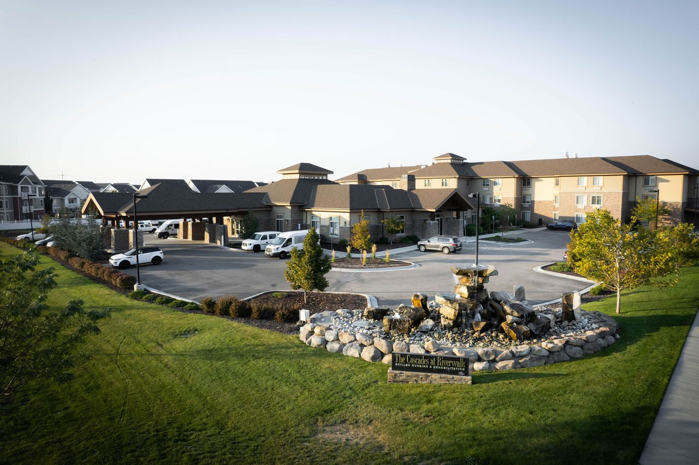 Exterior view of Cascades at Riverwalk facility with landscaping