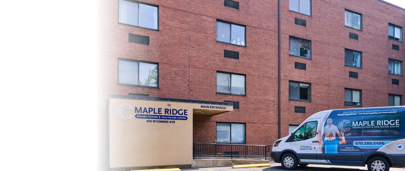Exterior view of Maple Ridge Rehabilitation center with entrance and van
