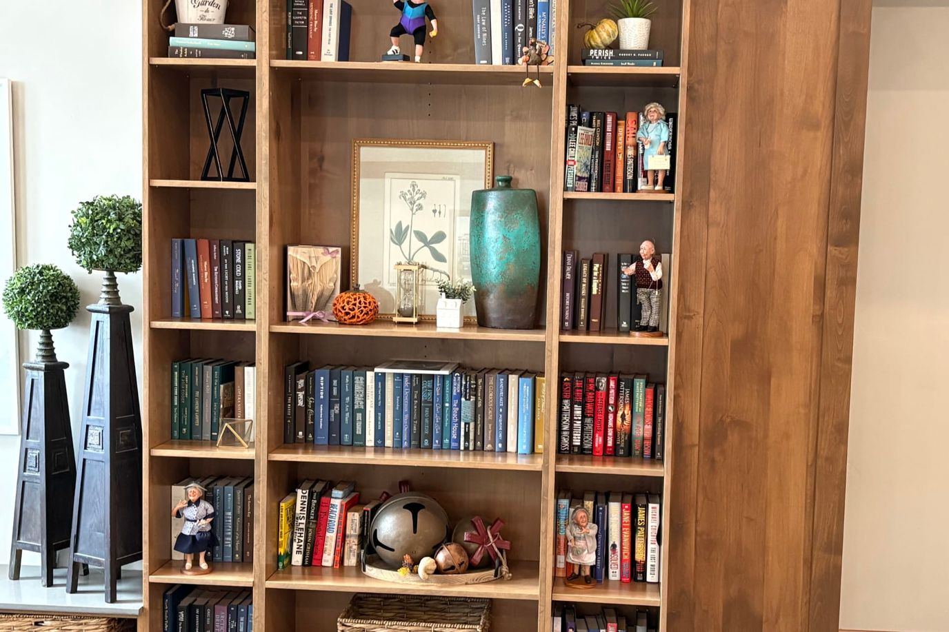 A wooden bookshelf filled with books and decorative items