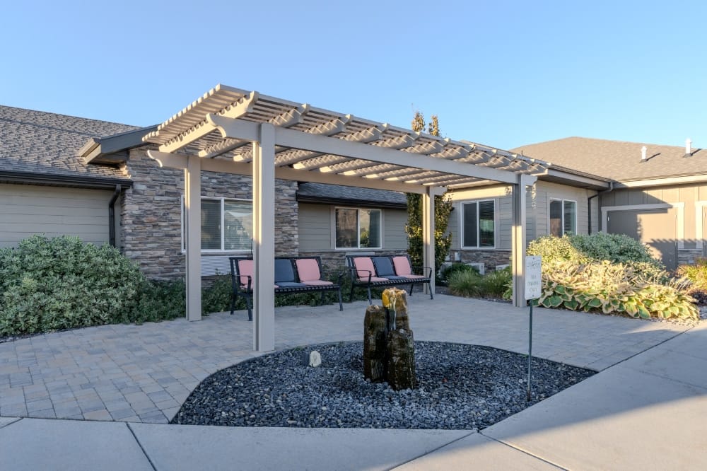 Outdoor seating area with pergola and landscaping