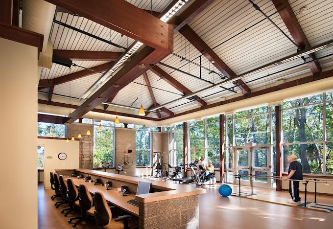 Interior view of a fitness area with residents exercising