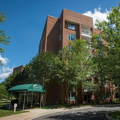 Exterior view of a senior living facility with green awning
