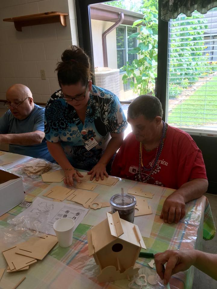 Resident and staff engaged in an arts and crafts activity