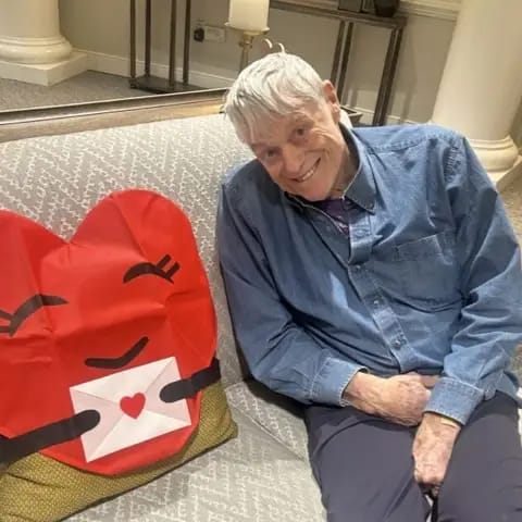 Resident smiling with a heart-shaped decoration