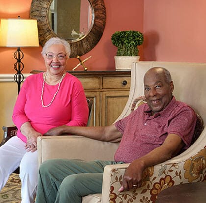 Two residents smiling in a comfortable sitting area
