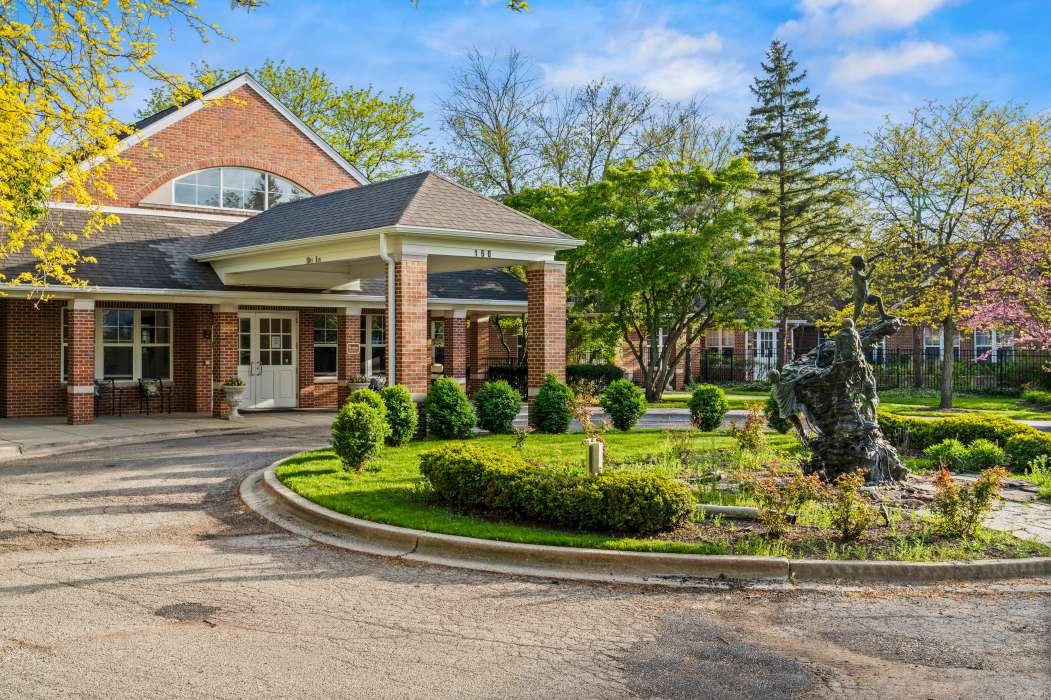 Exterior view of Serenity Estates with gardens and sculpture