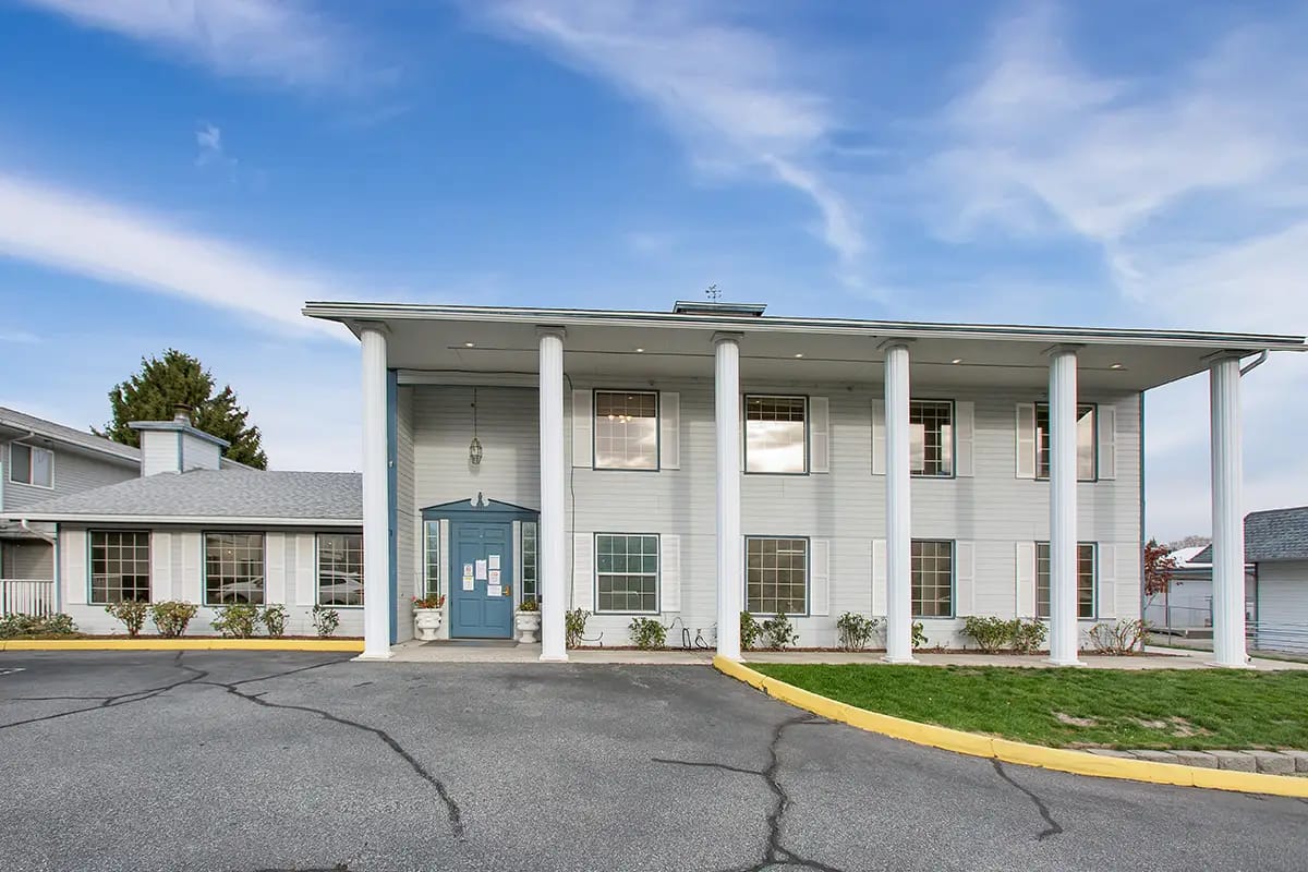 Exterior view of a senior living facility with porch