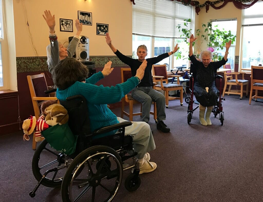 Residents participating in a seated exercise activity