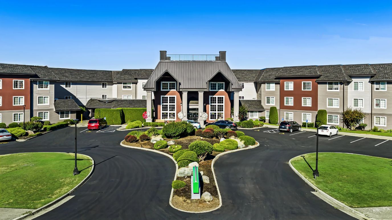 Exterior view of Meadow Greens facility with landscaped entrance