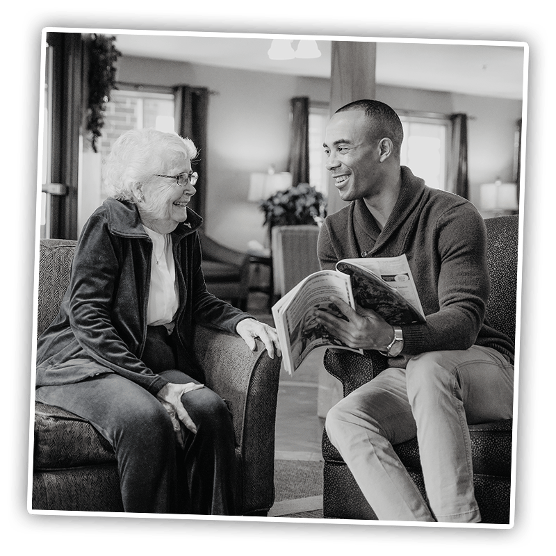 Resident and staff member enjoying conversation in a common area