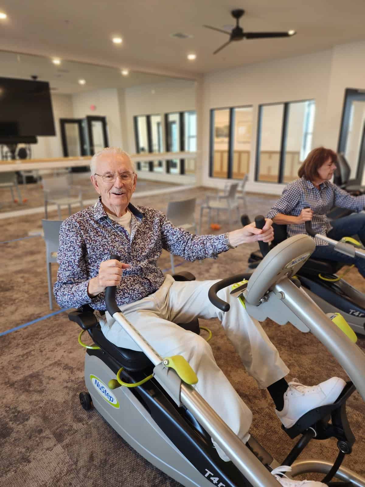 A resident using an exercise machine in an activity room