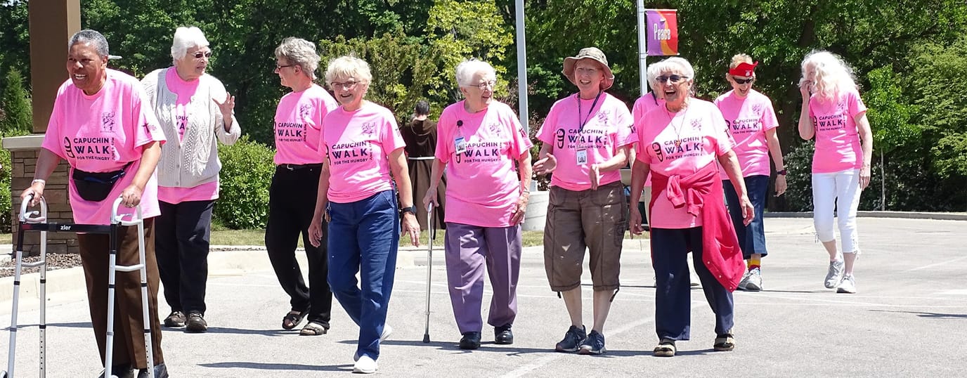 Franciscan Shore, assisted living in St Francis, WI — Seniors participating in a community walk wearing pink shirts