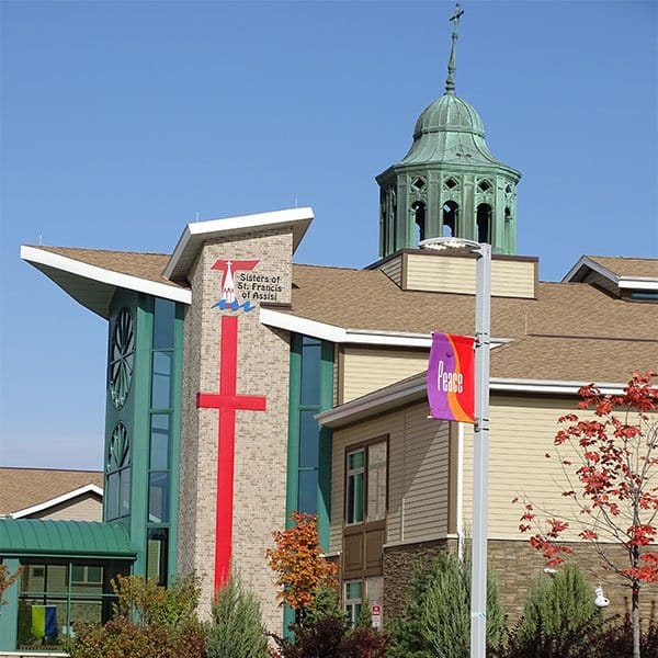 Franciscan Shore, assisted living in St Francis, WI — Building exterior featuring cross and bell tower