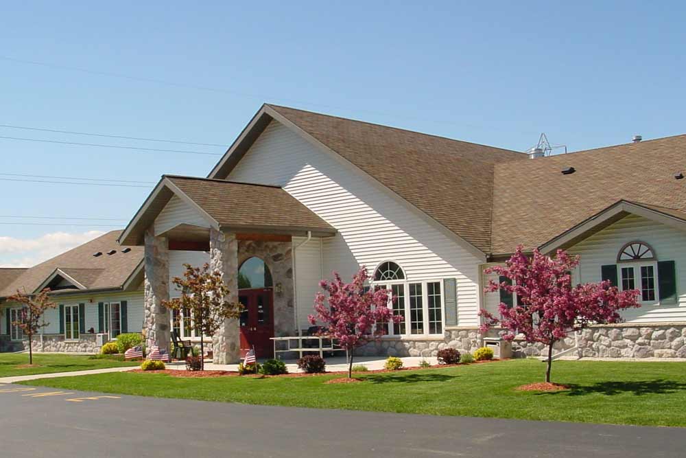 Front exterior of Kettle Moraine Gardens with flowering trees