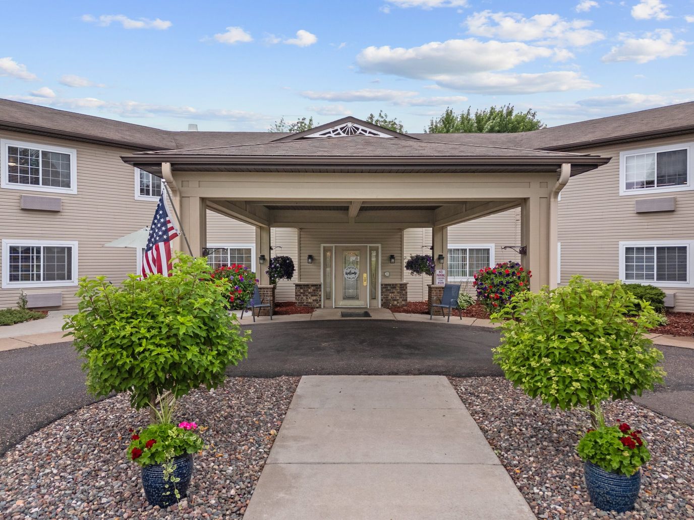 Exterior view of Oak Gardens Place entrance with flowers