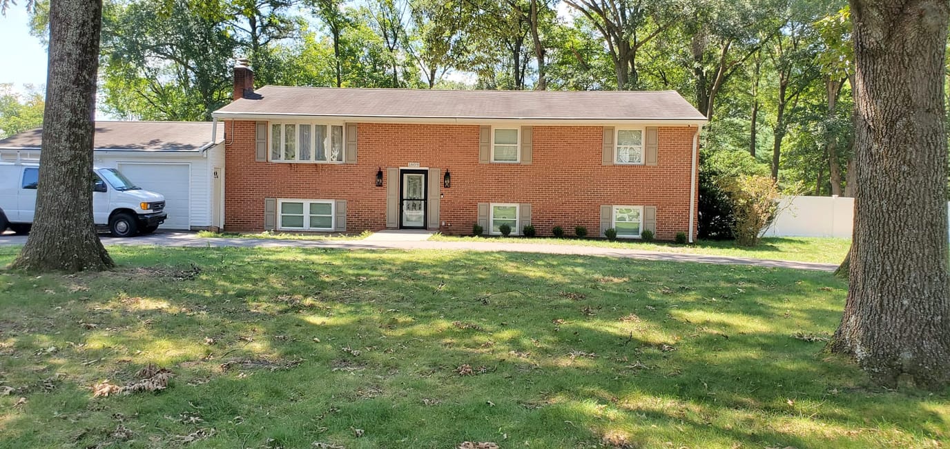 Exterior view of a senior living facility with grassy front yard