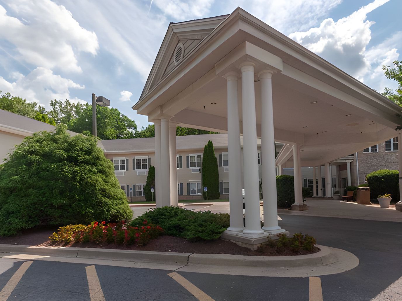 Welcoming entrance of a senior care facility with landscaping