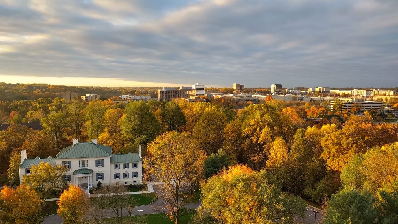 Aerial view of Cedar Place surrounded by autumn foliage