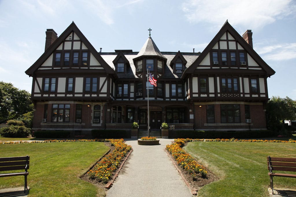 Exterior view of a skilled nursing facility with gardens