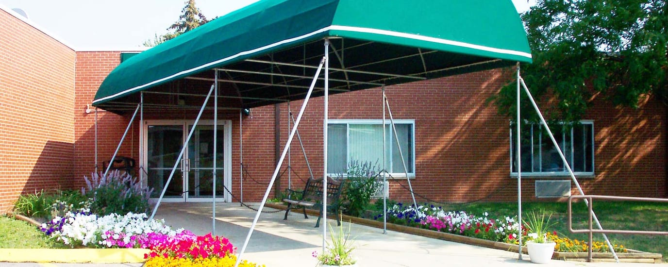 Entrance canopy with flowers at the facility