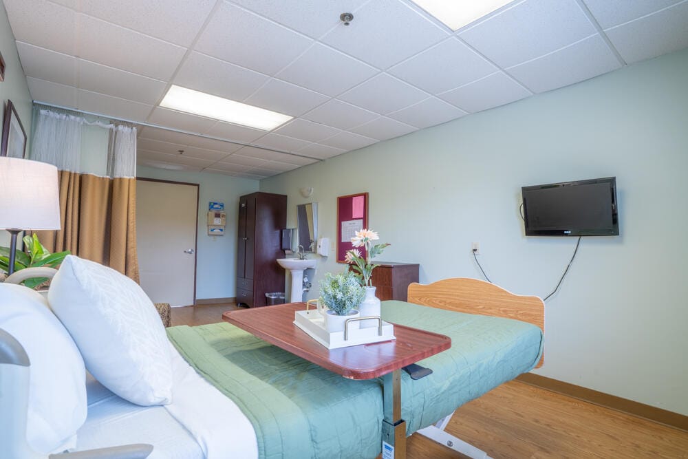 Cozy resident room with a bed and TV