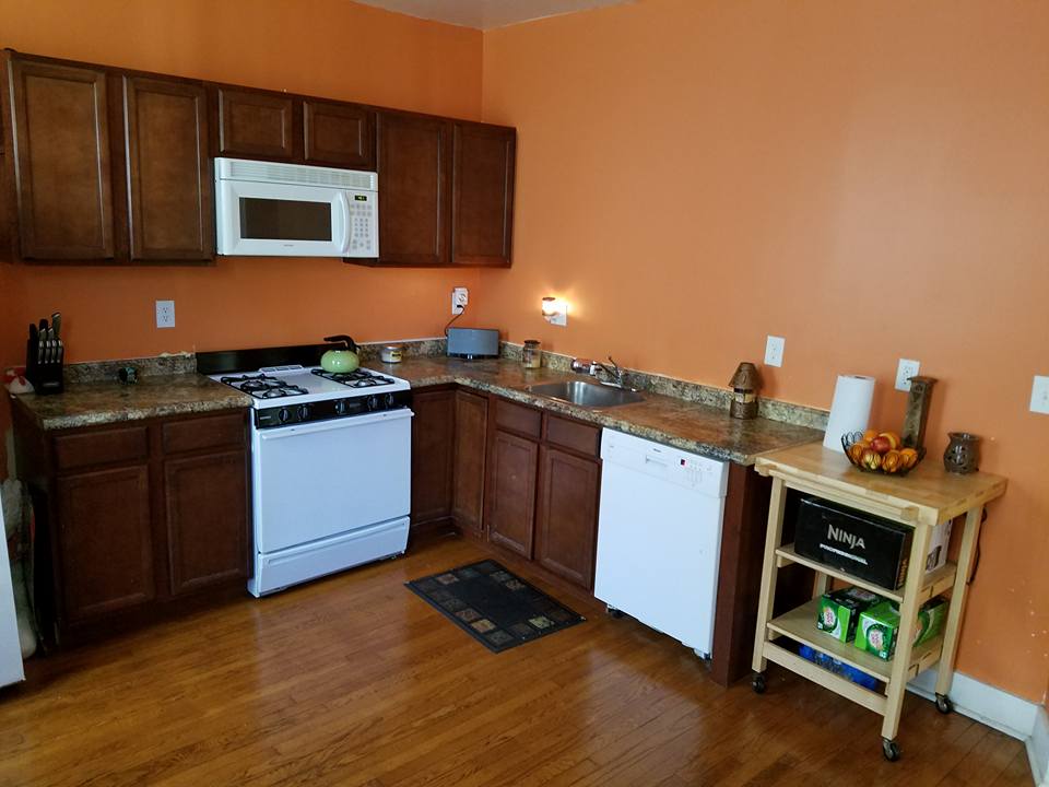 Bright kitchen area with appliances and countertops