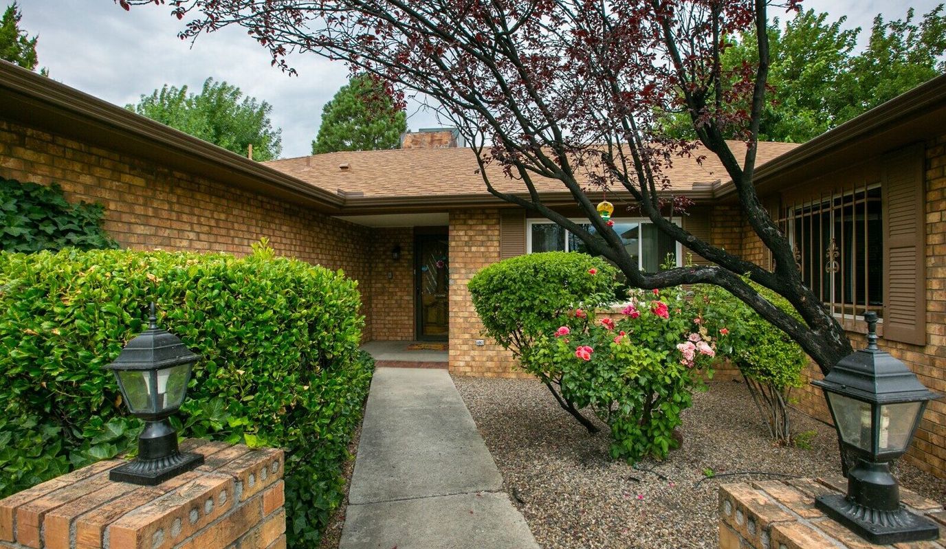 Entrance of Haven Care Cottonwood House with landscaped garden