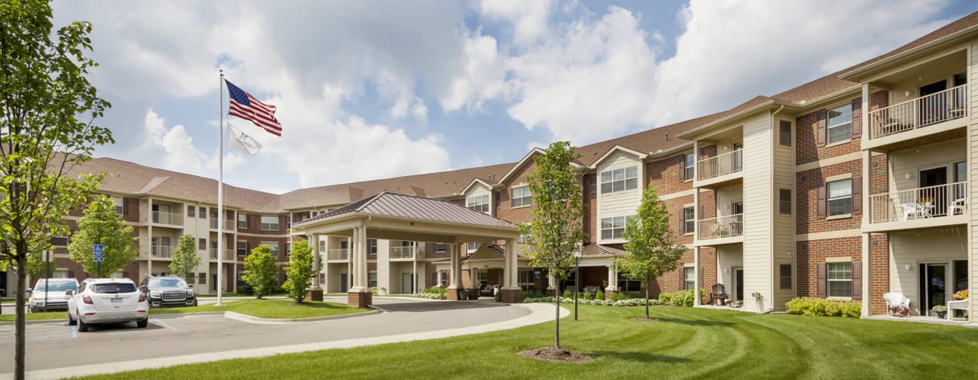 Front exterior of the nursing facility with flag and landscaping