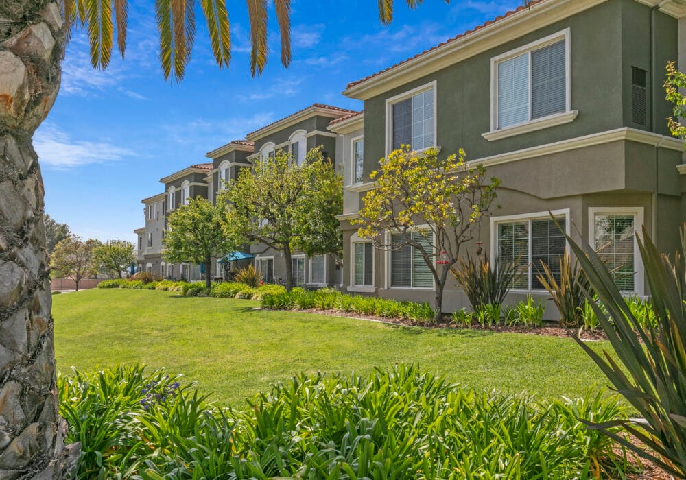 Exterior view of a senior living facility with landscaping