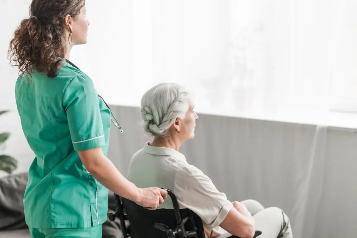 Caregiver assisting a resident indoors