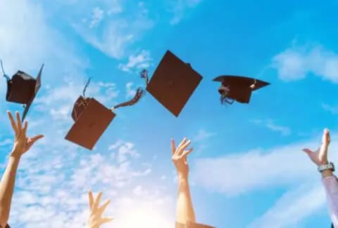 Graduates tossing caps into the sky
