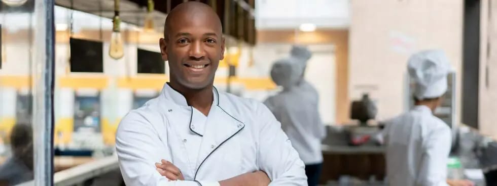 Chef smiling in a kitchen environment